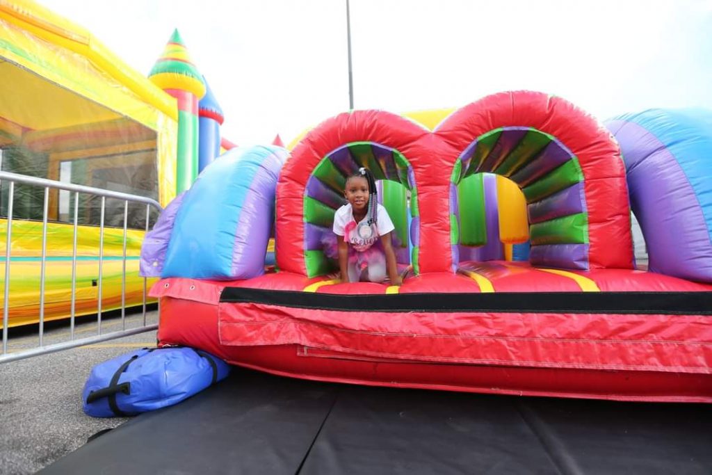 Little girl in an inflatable bounce house.